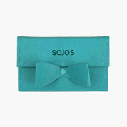 Teal sunglasses case with bow, open case with sunglasses, and pink and teal organizer on a white background